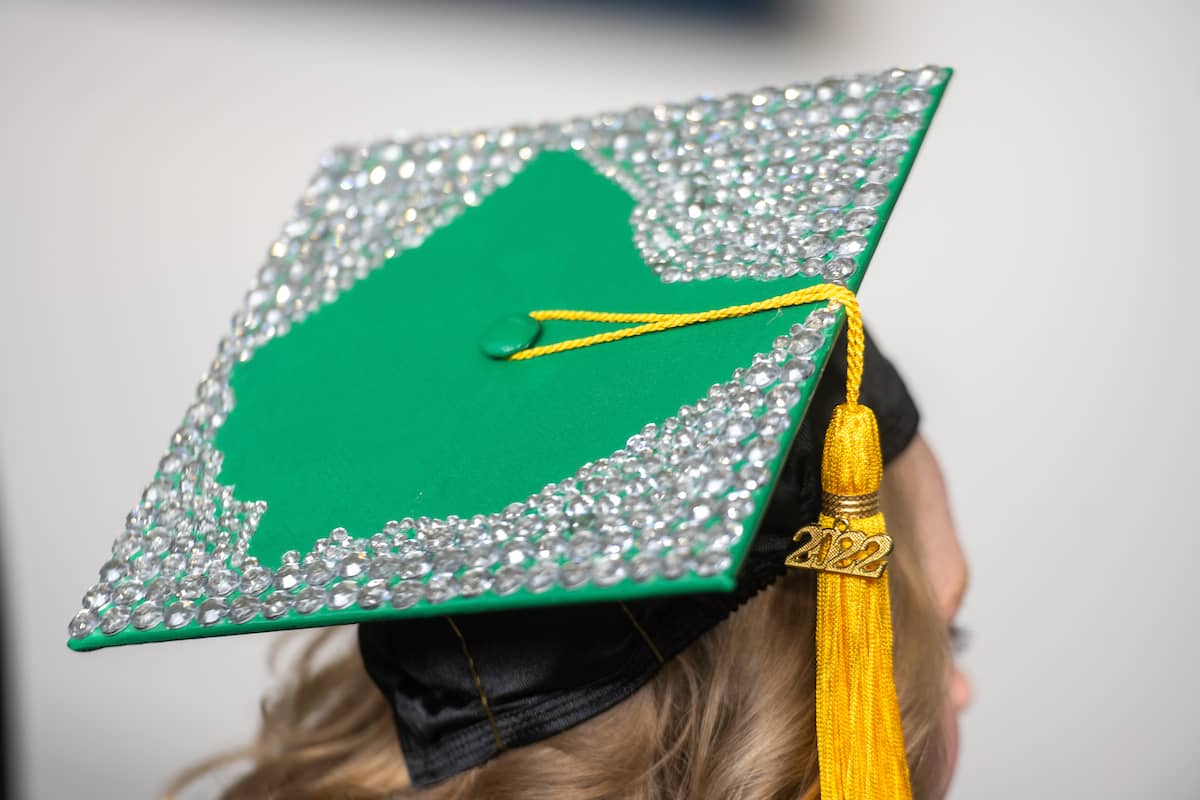 Student wearing a graduating cap with the state of Ohio outline