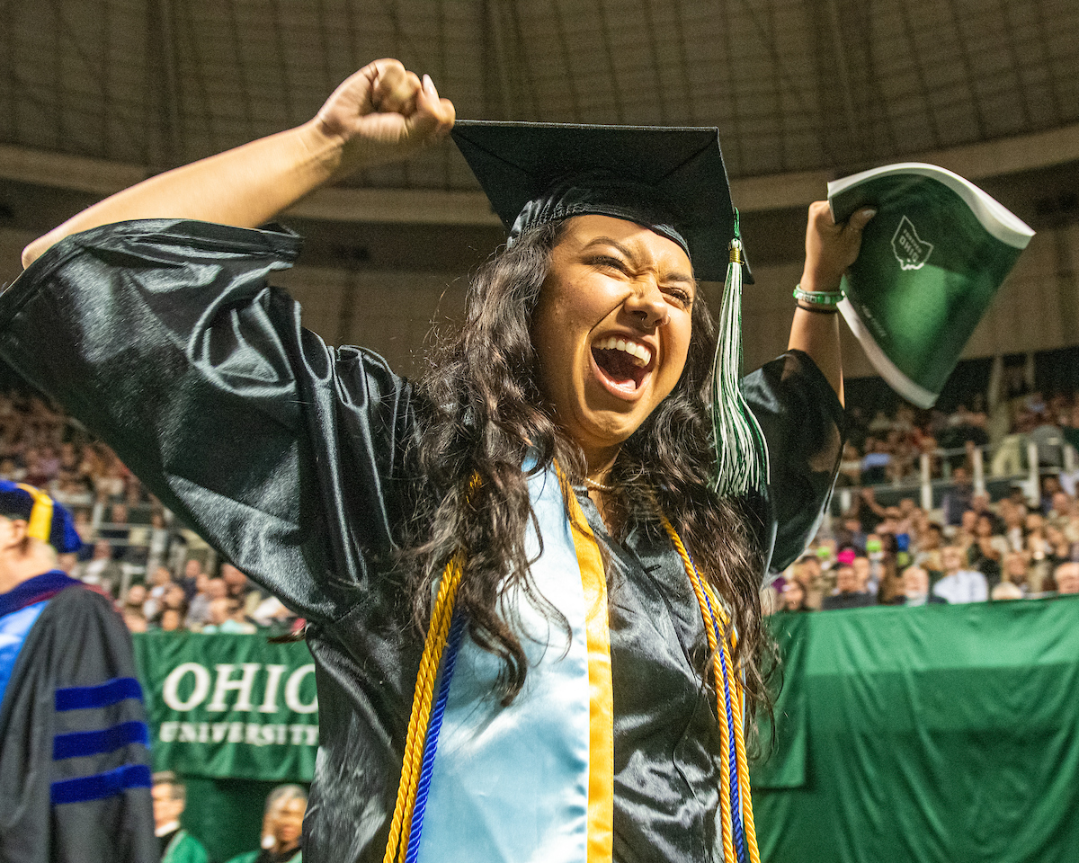 A graduate celebrates at Spring Commencement 2022.