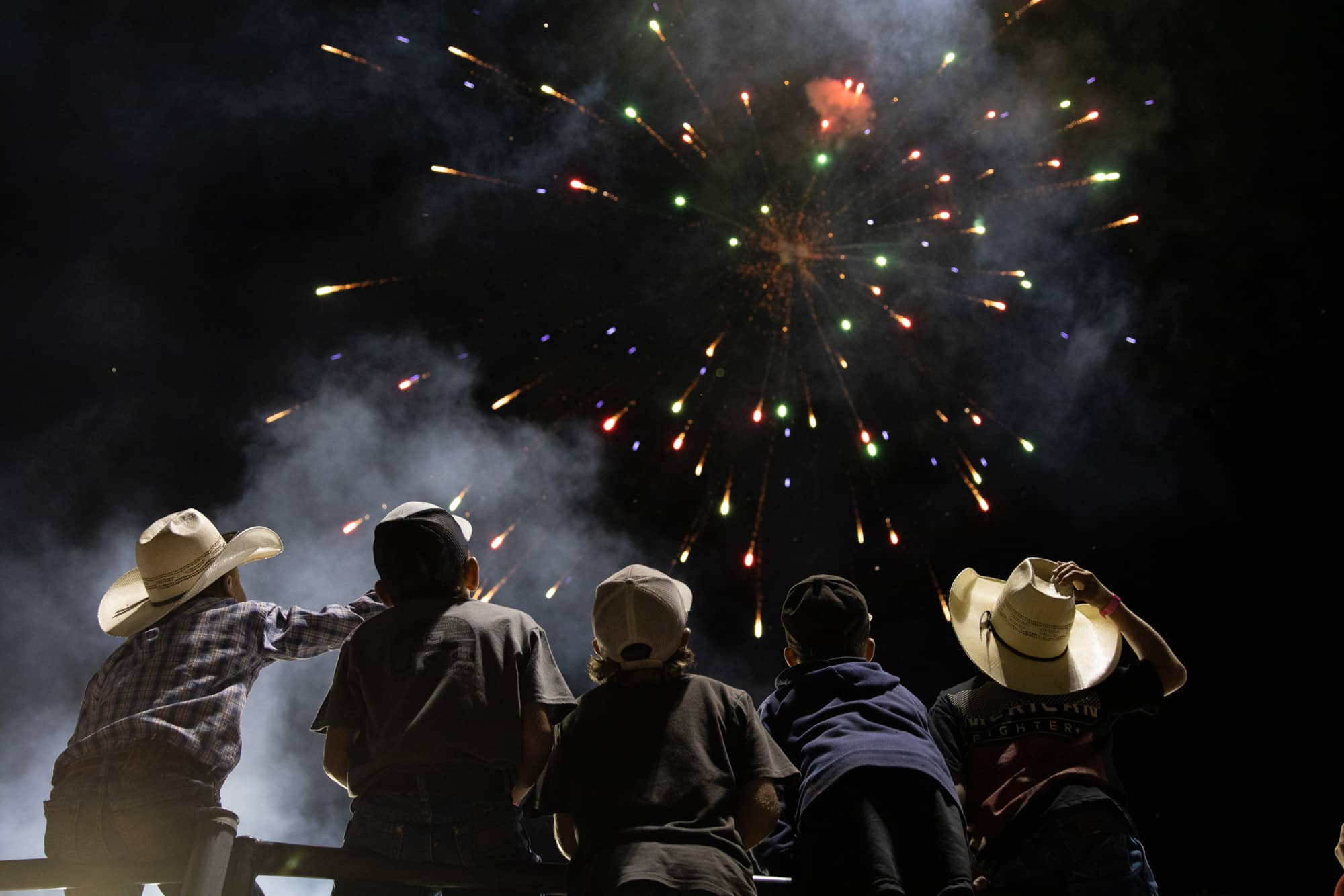 Children watch the fireworks during the Lincoln County Fair and Rodeo in Panaca, Nevada, on Friday Aug. 12, 2022.