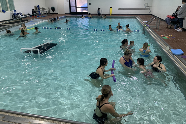 Instructors work with children in the pool at Beacon School.