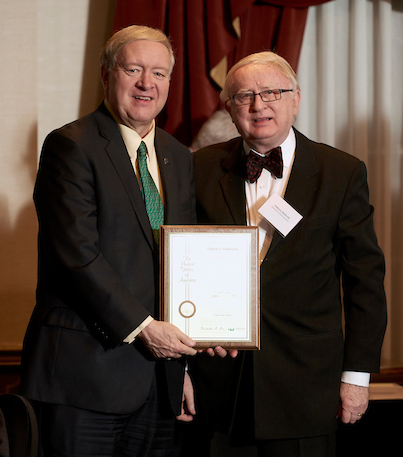 Duane Nellis and Tadeusz Malinski holding an award