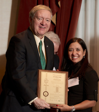 Duane Nellis and Gerardine Botte holding award