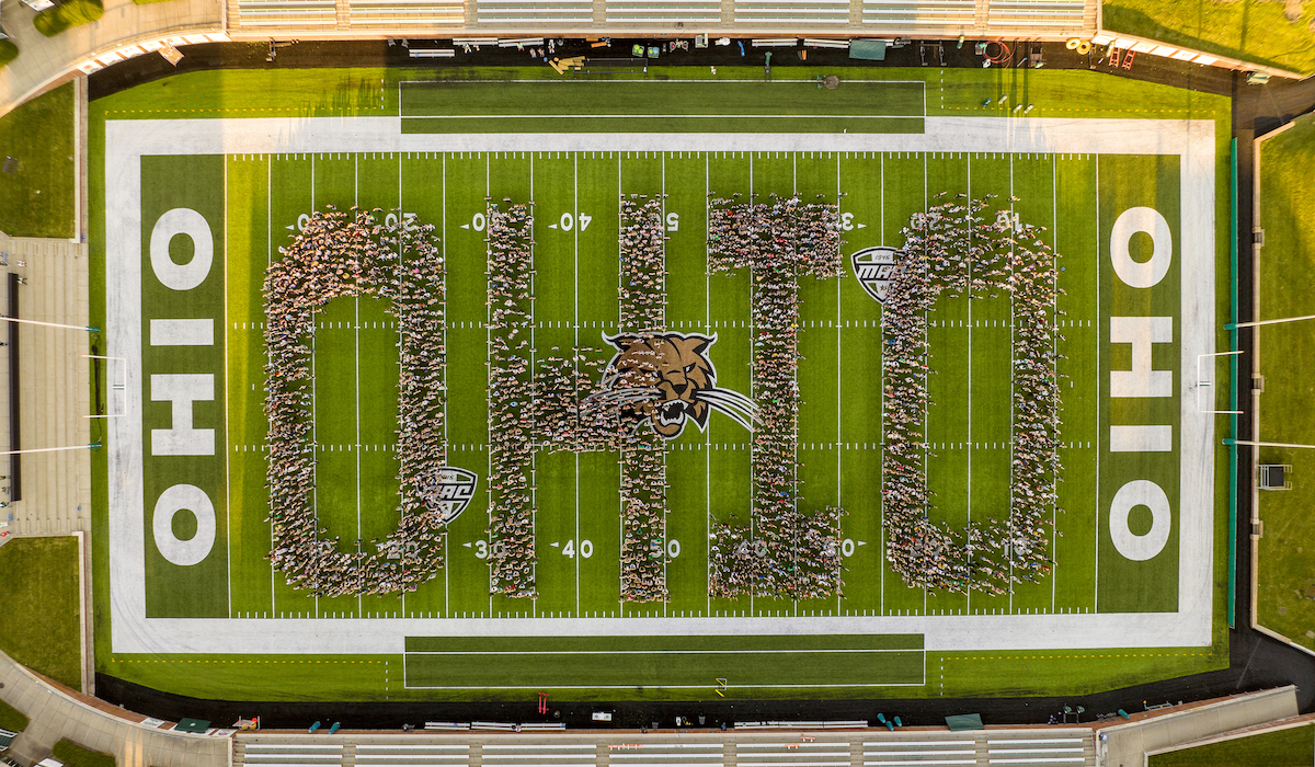 Students spelling out OHIO by standing in Peden Stadium