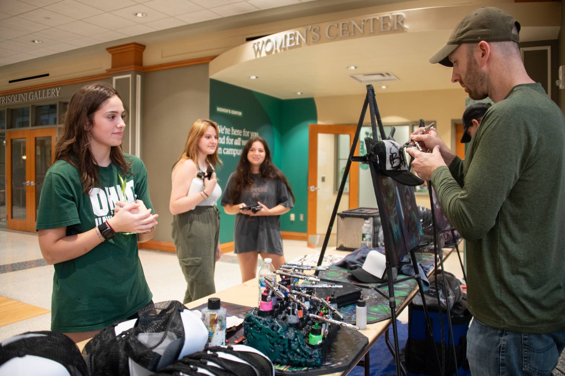 A student waits for a custom hat to be made for them at the Baker Bash.