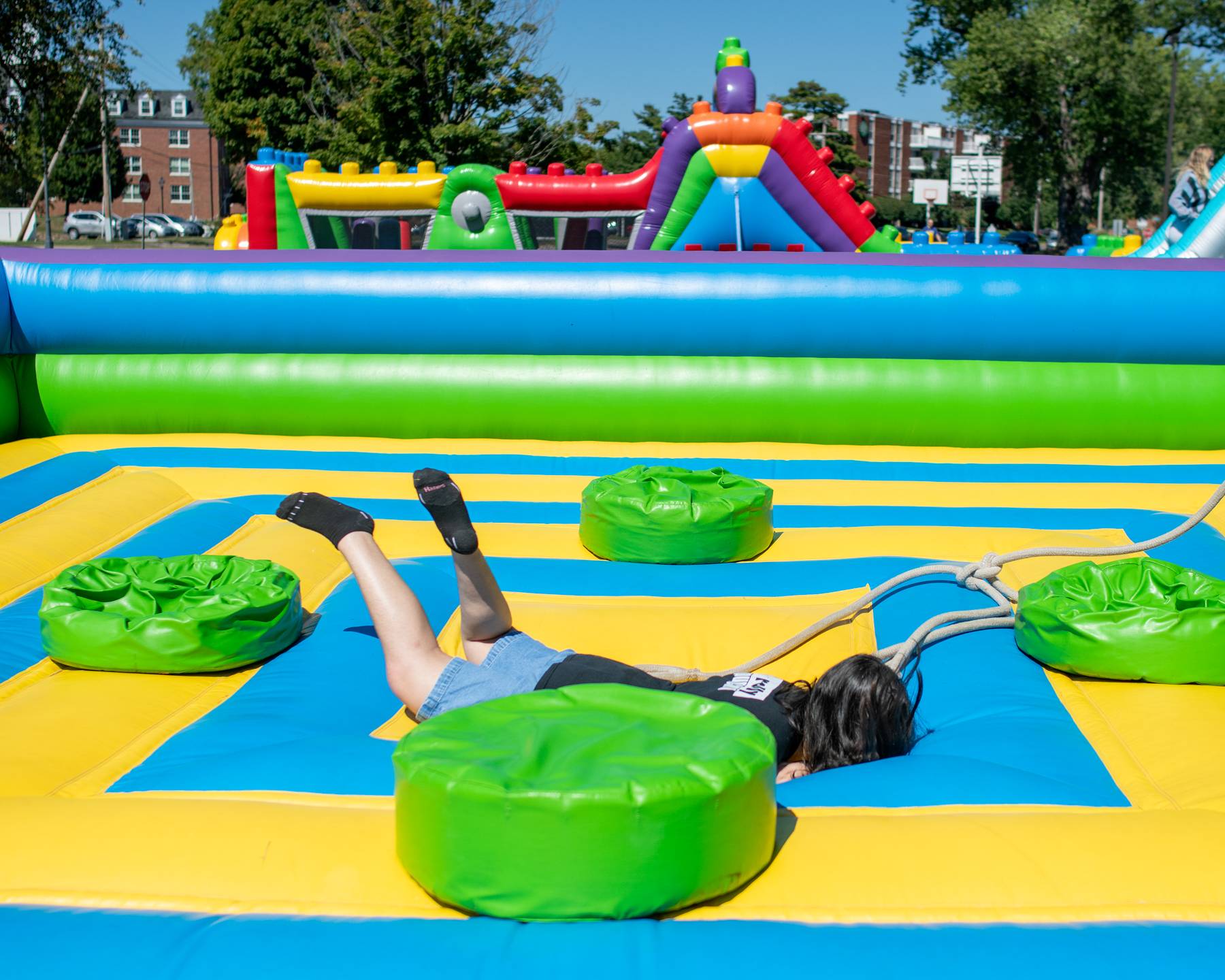 A students falls from an inflatable on South Beach.