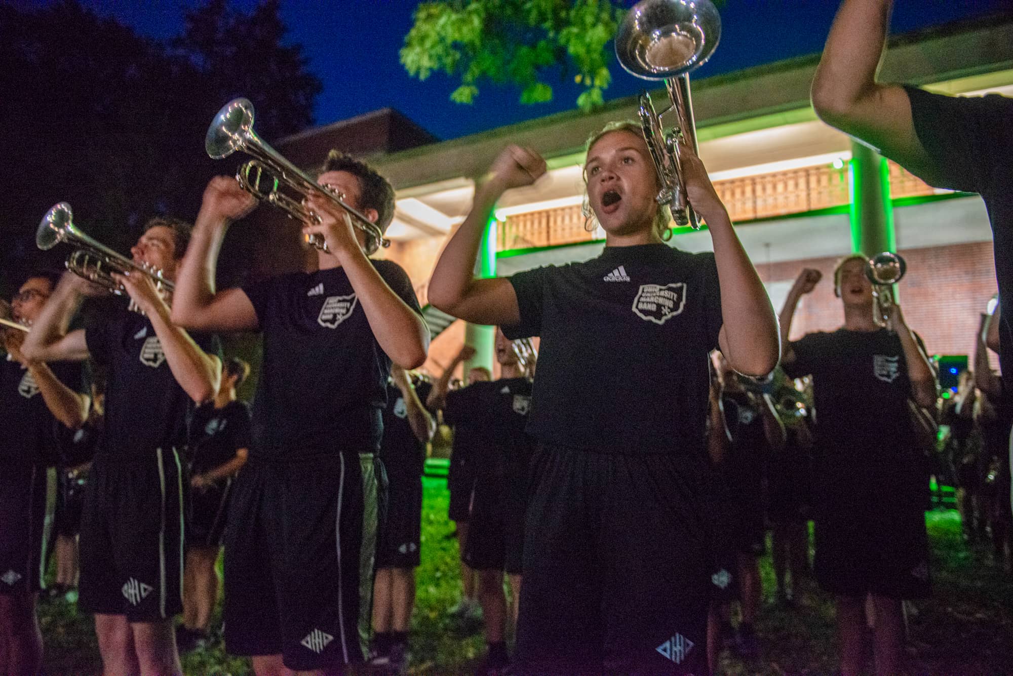Members of the Marching 110 lead a cheer at Yell Like Hell on College Green.
