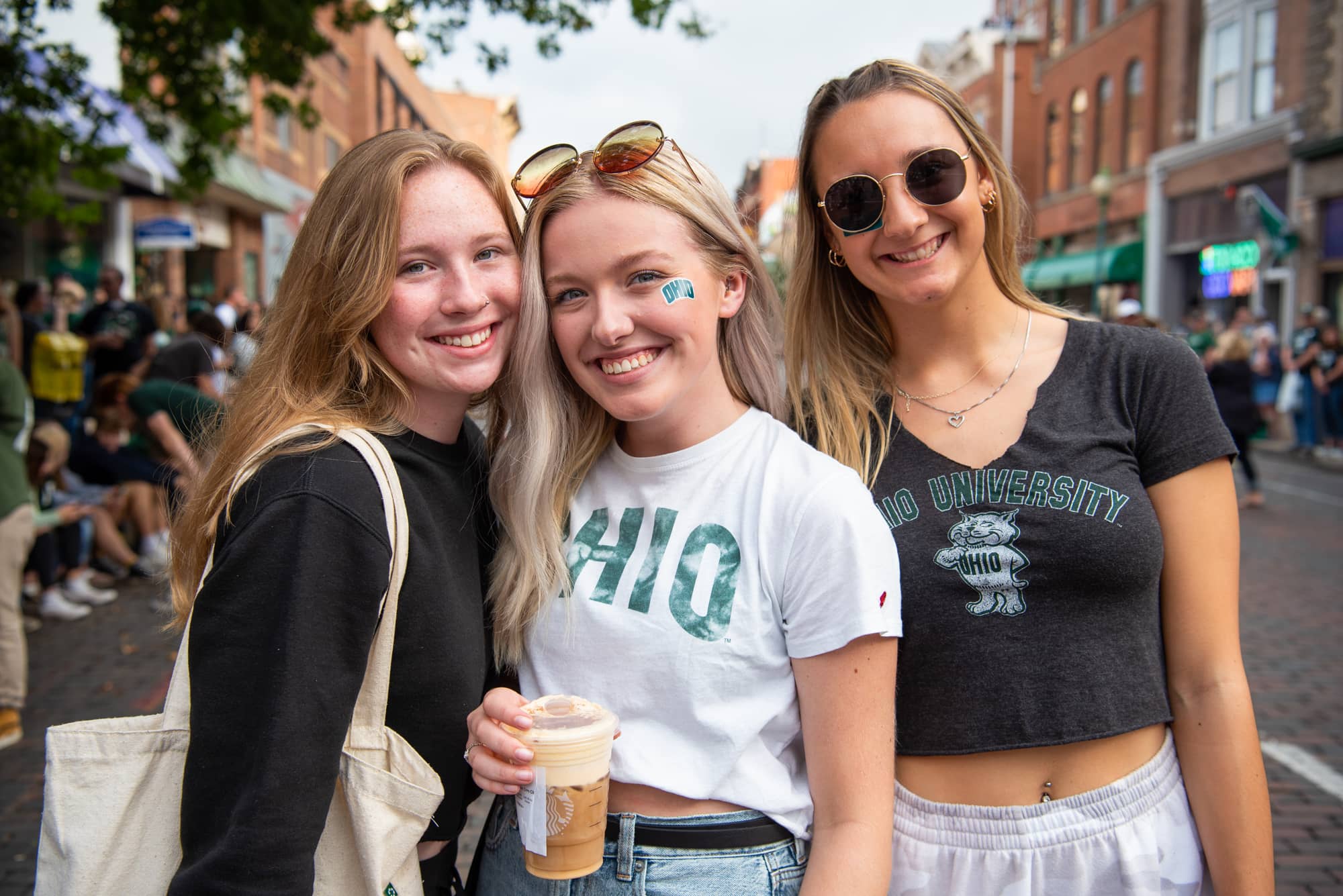 Students pause for a photo together at the Homecoming Parade.