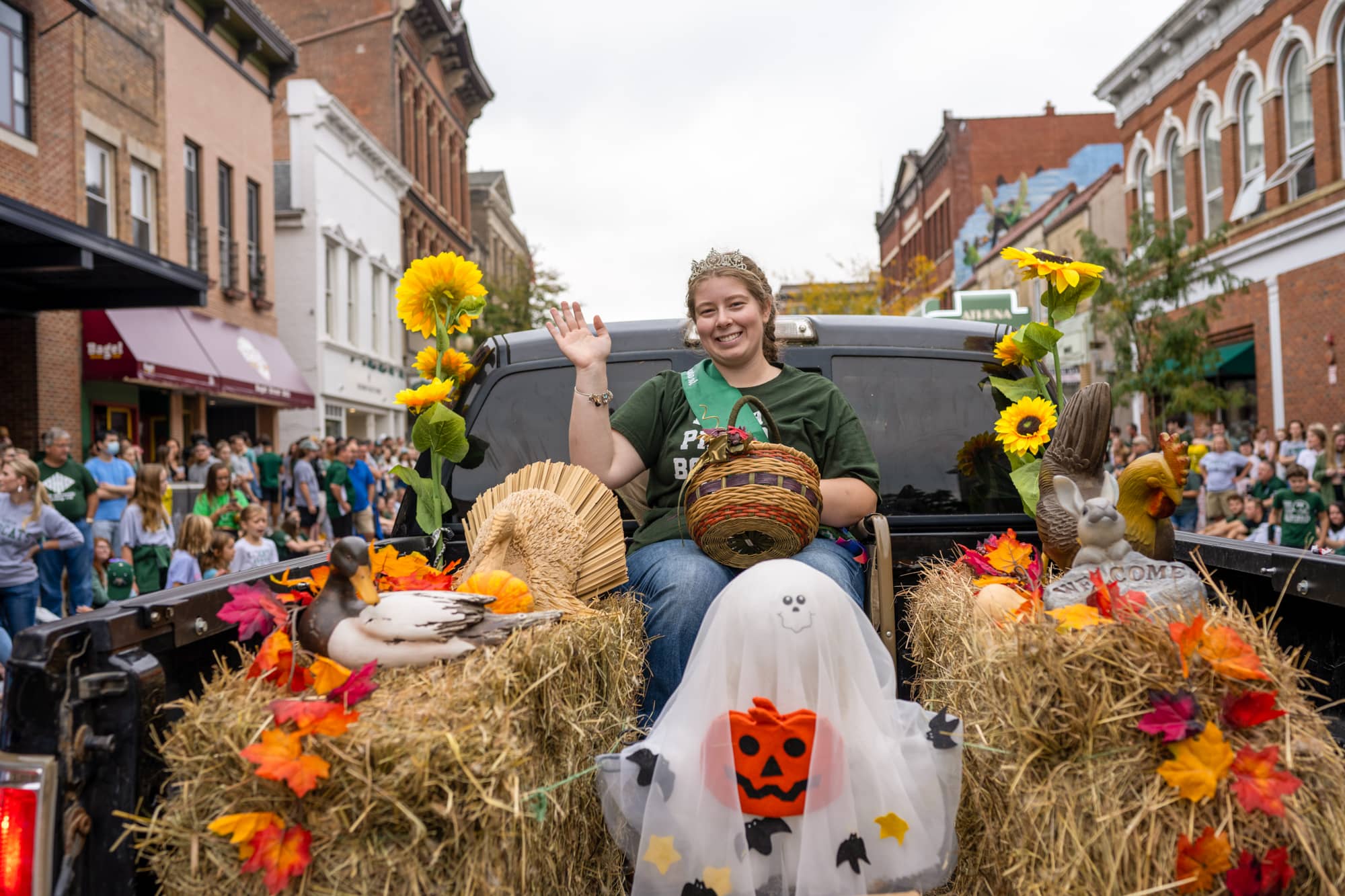 A community member participates in the Homecoming parade on behalf of 4 H. 