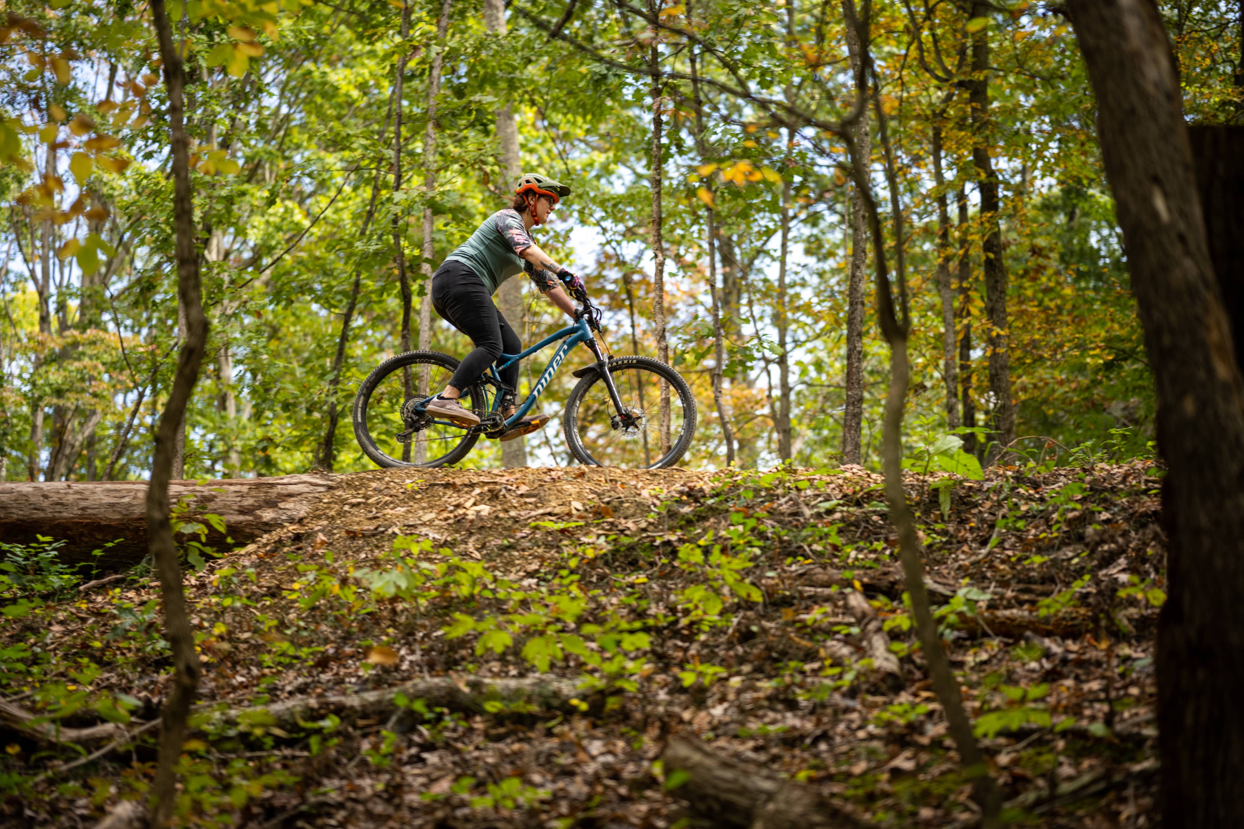 A graduate student mountain bikes at the Baileys Trail System near the Athens Campus.