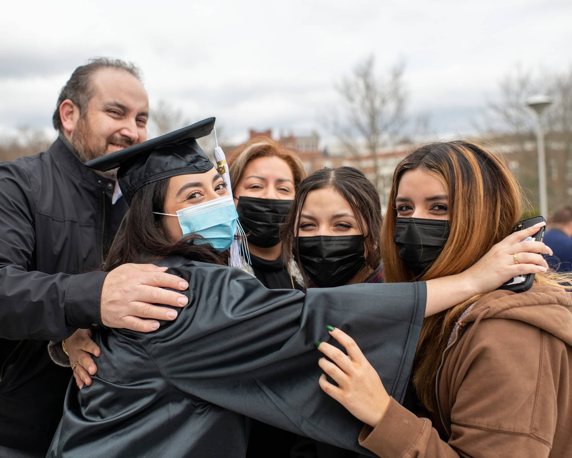 A graduate and is surrounded by her family after the Fall Commencement 2021 at the Athens Campus. 