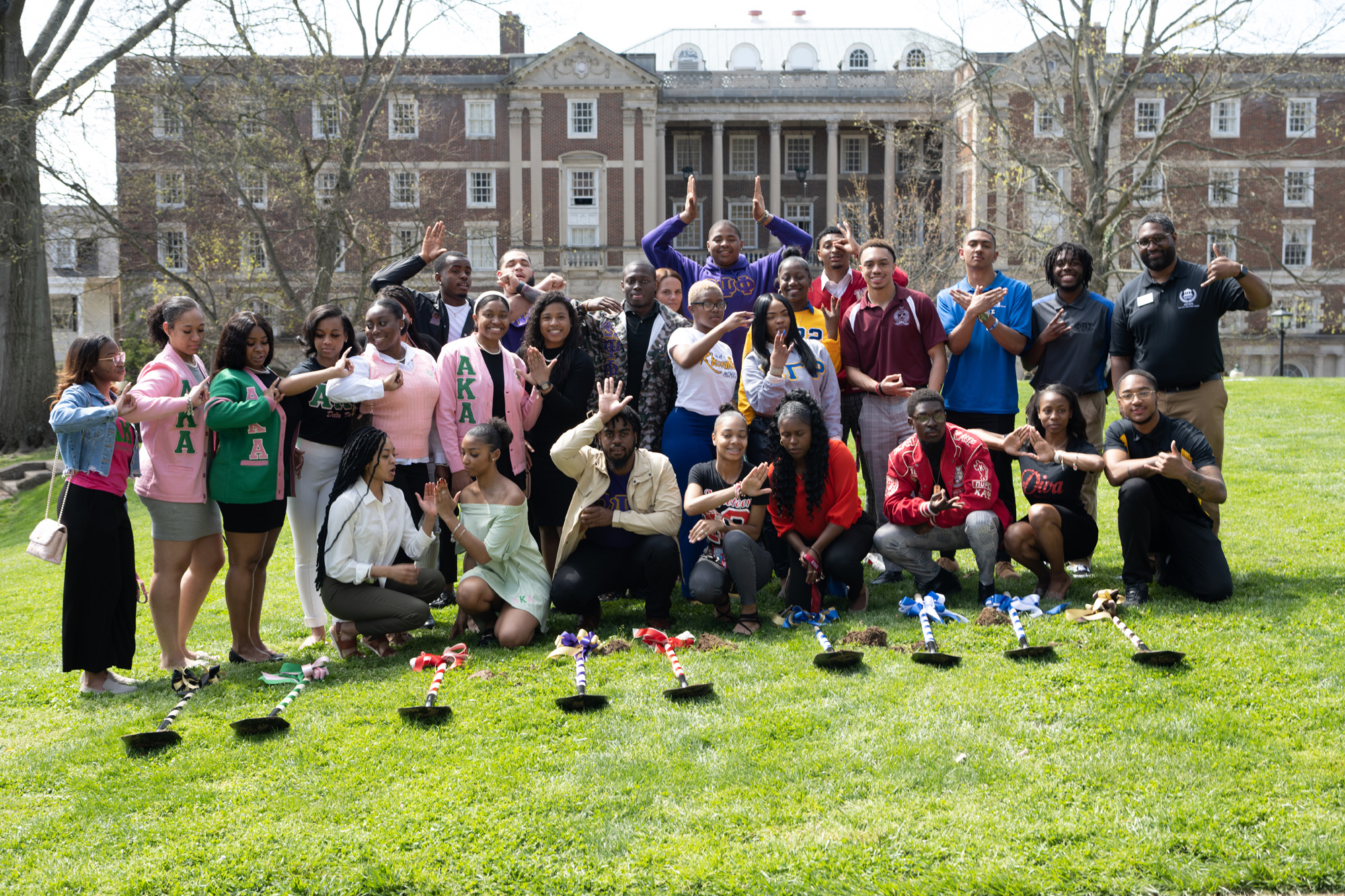 Students pose for a photo at a groundbreaking ceremony for the National Pan-Hellenic Council Plaza on College Green on April 22, 2022.