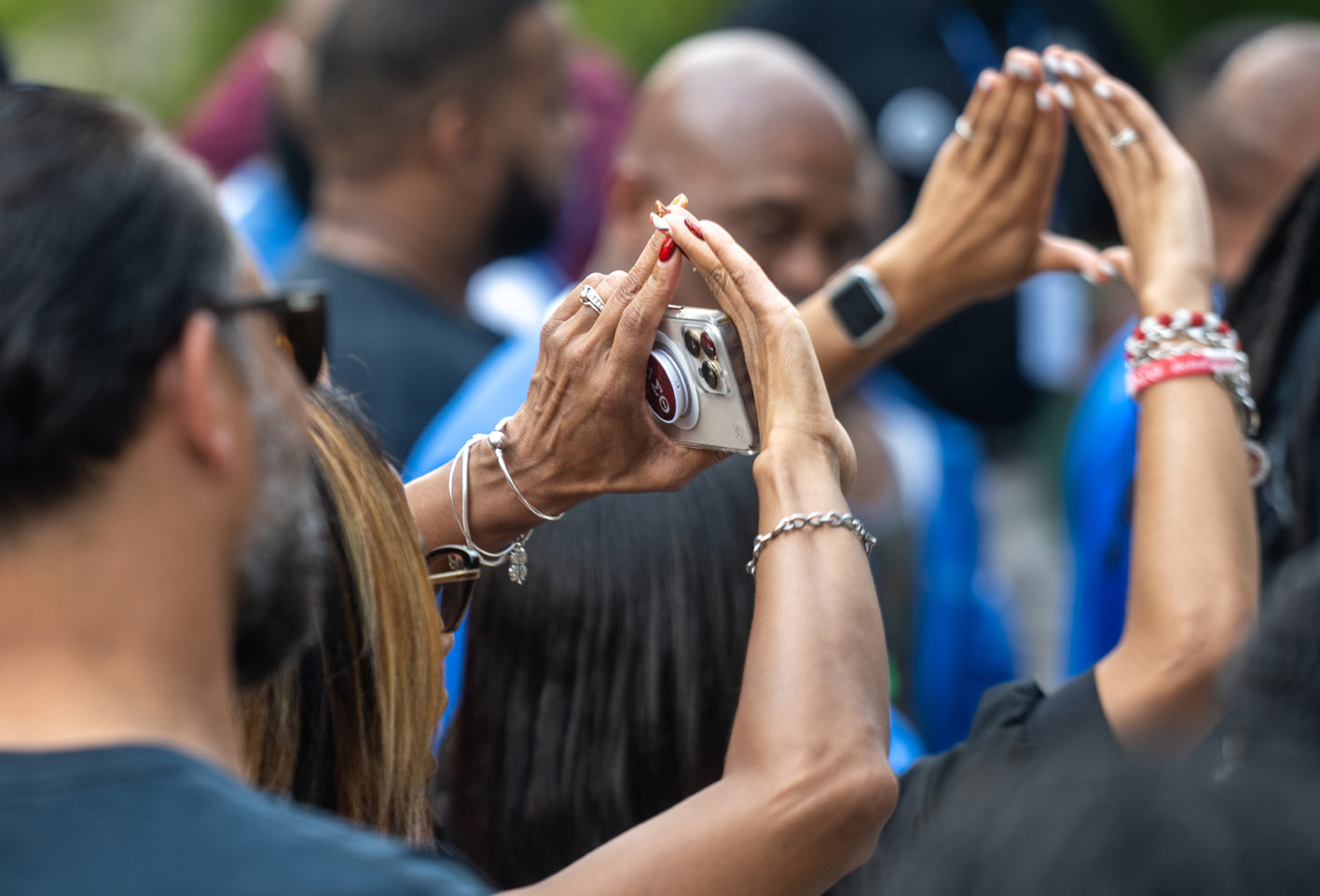 Alumni pose for a photo while being recognized during the dedication of the National Pan-Hellenic Council Plaza on College Green.