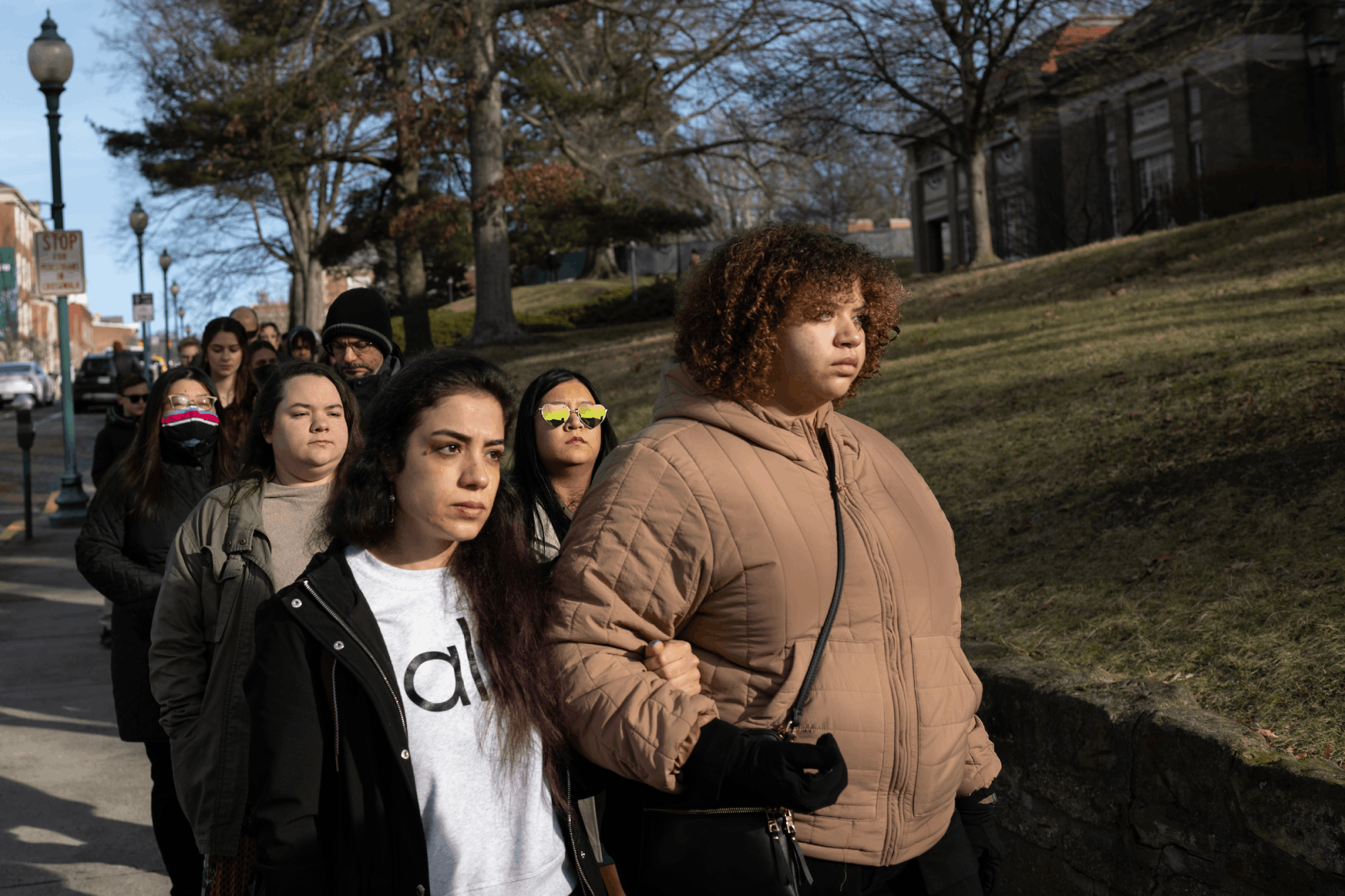 With linked arms, participants in the Martin Luther King Jr. Celebration Silent March make their way to Baker University Center.