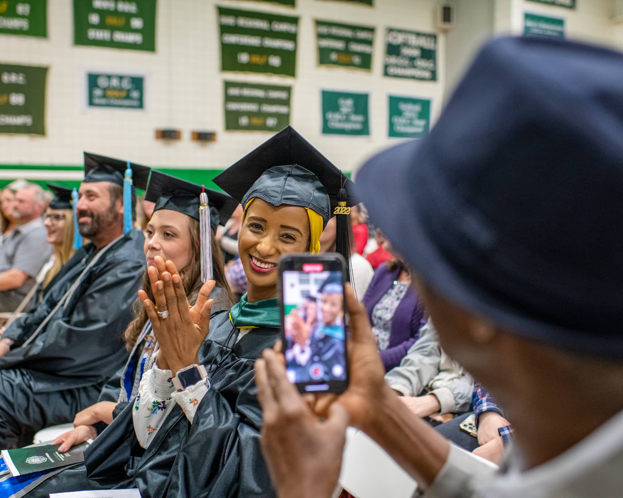 A student poses for a photo on during a graduation recognition ceremony on the Lancaster Campus.