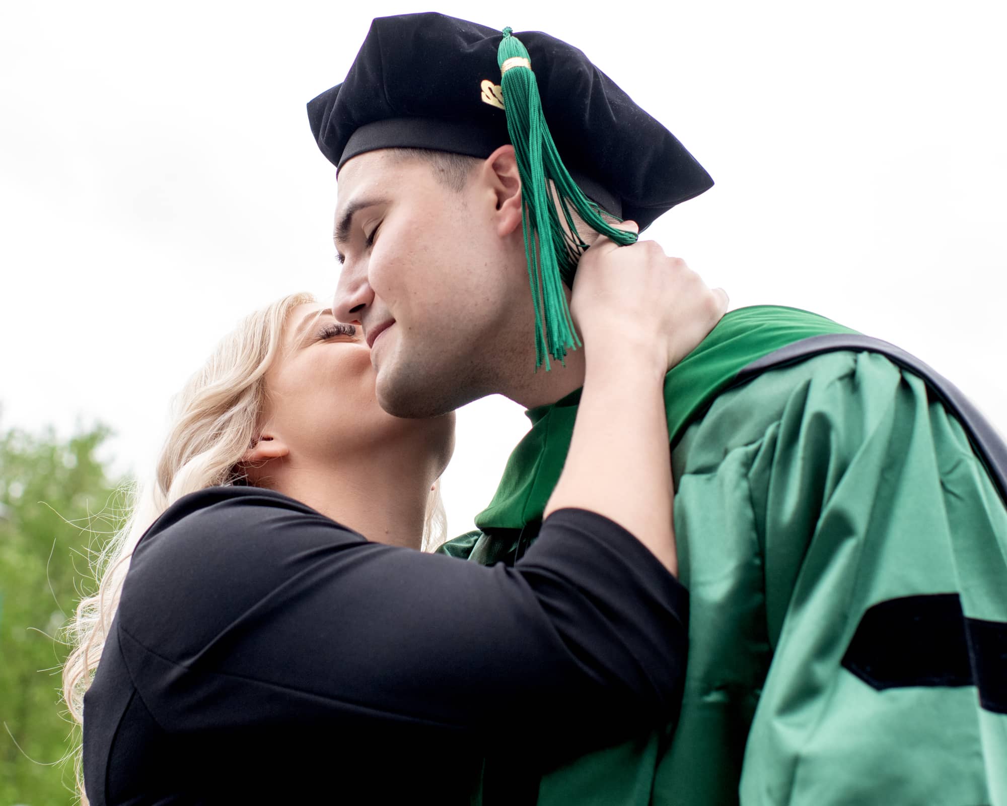 A Heritage College graduate is congratulated following commencement.