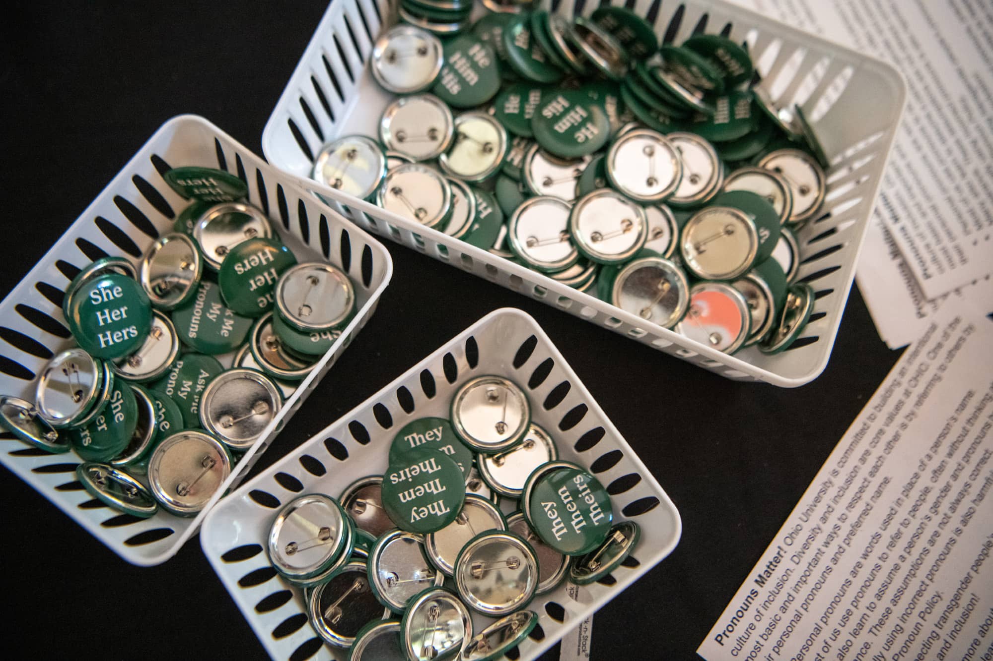 Baskets of pronoun buttons greet students and their guests at an OHIO History and Traditions presentation at Templeton-Blackburn Memorial Auditorium.