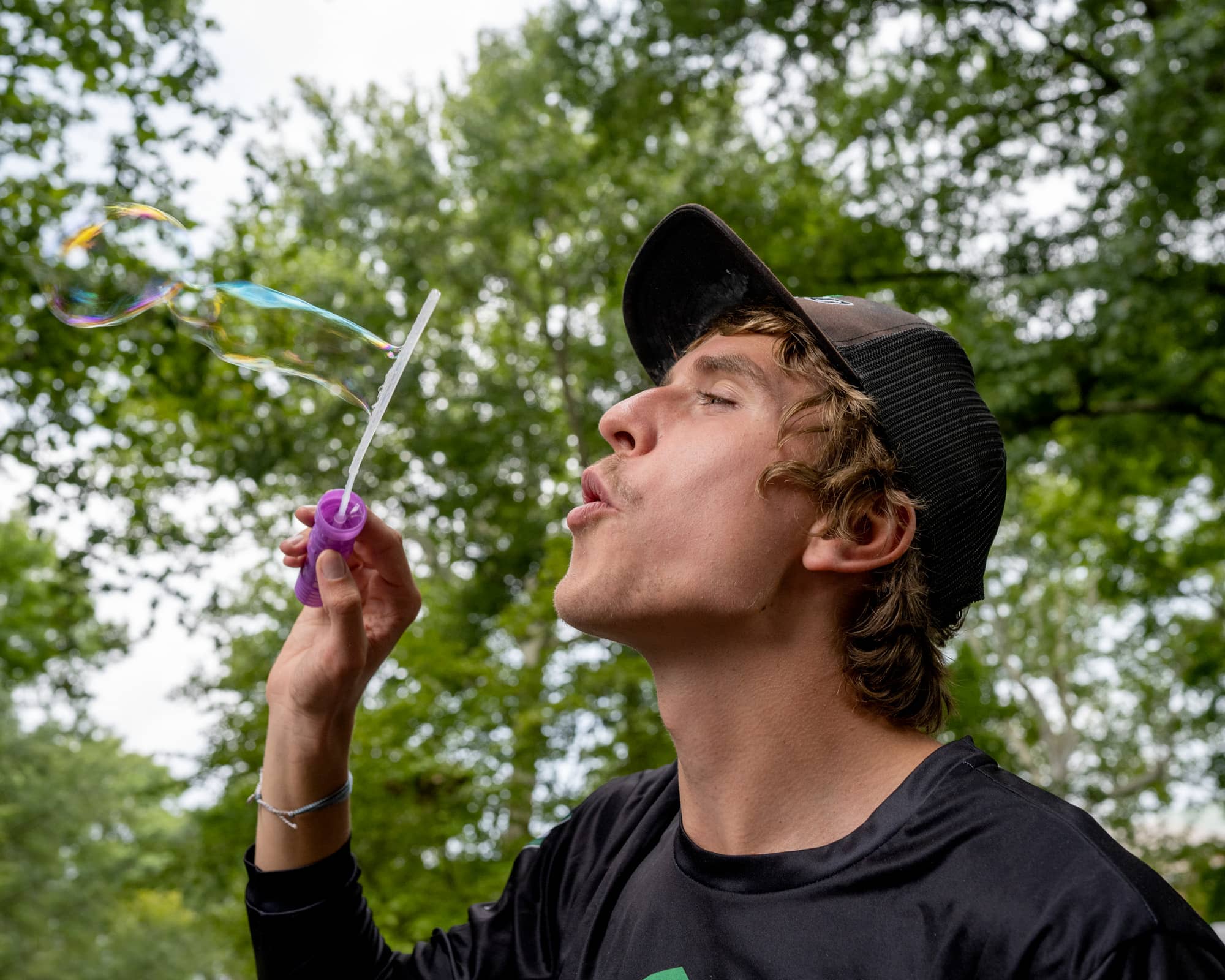 A student blows bubble at the Student Organization Involvement Fair.