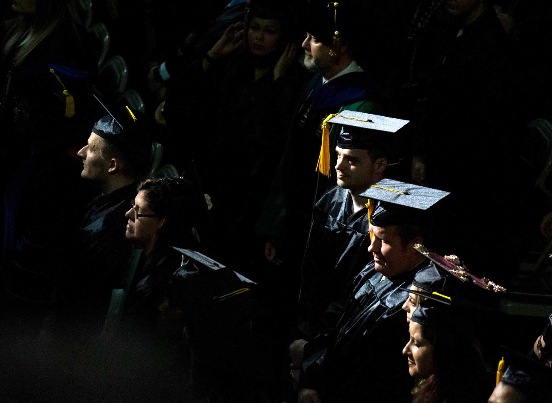 Graduates standing in the crowd during 2019 Fall Commencement.