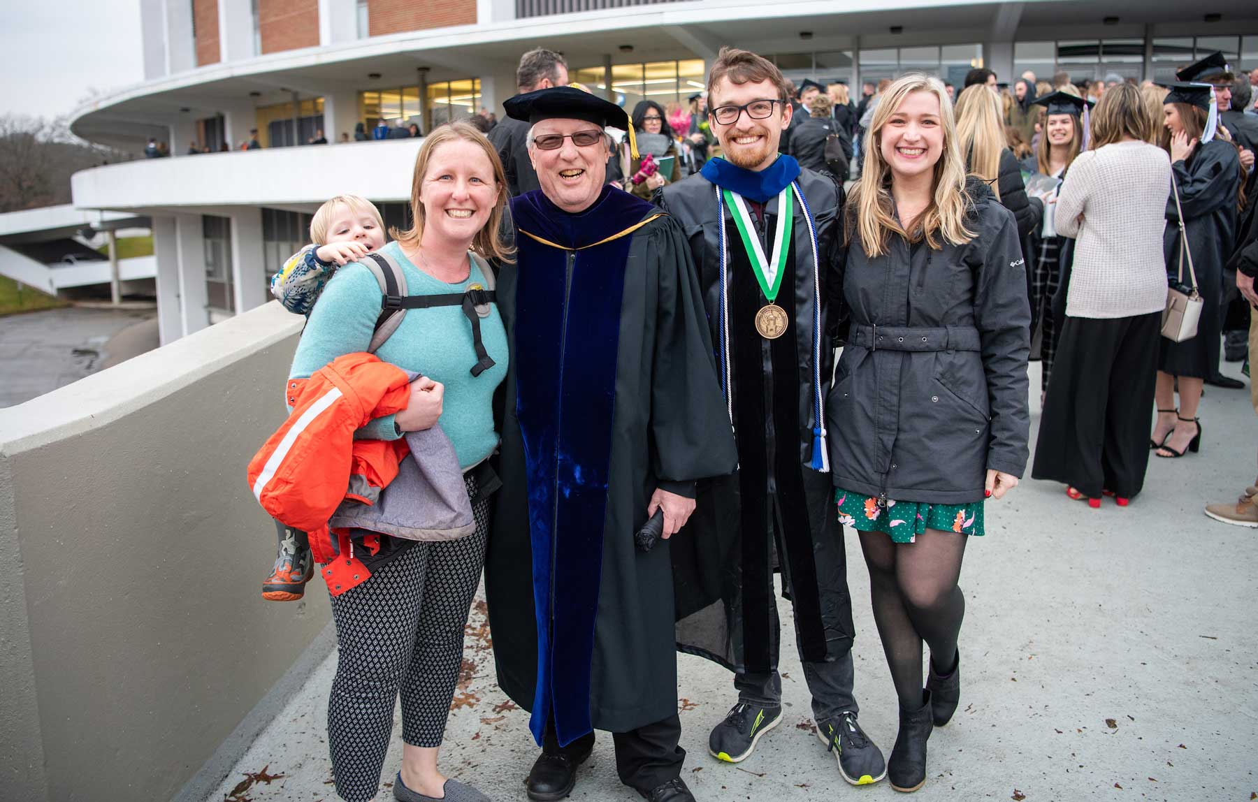 A family posing outside the Convo after 2019 Fall Graduation
