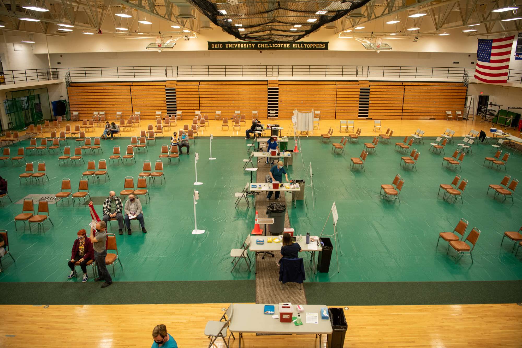 Rows of chairs set up in a gymnasium at arbitrary safe distances