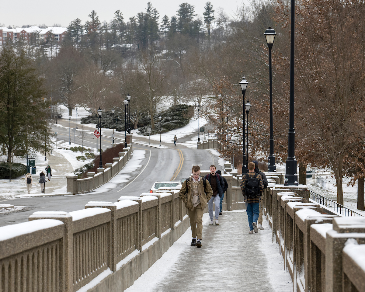 Students walk up a hill to classes in the snow