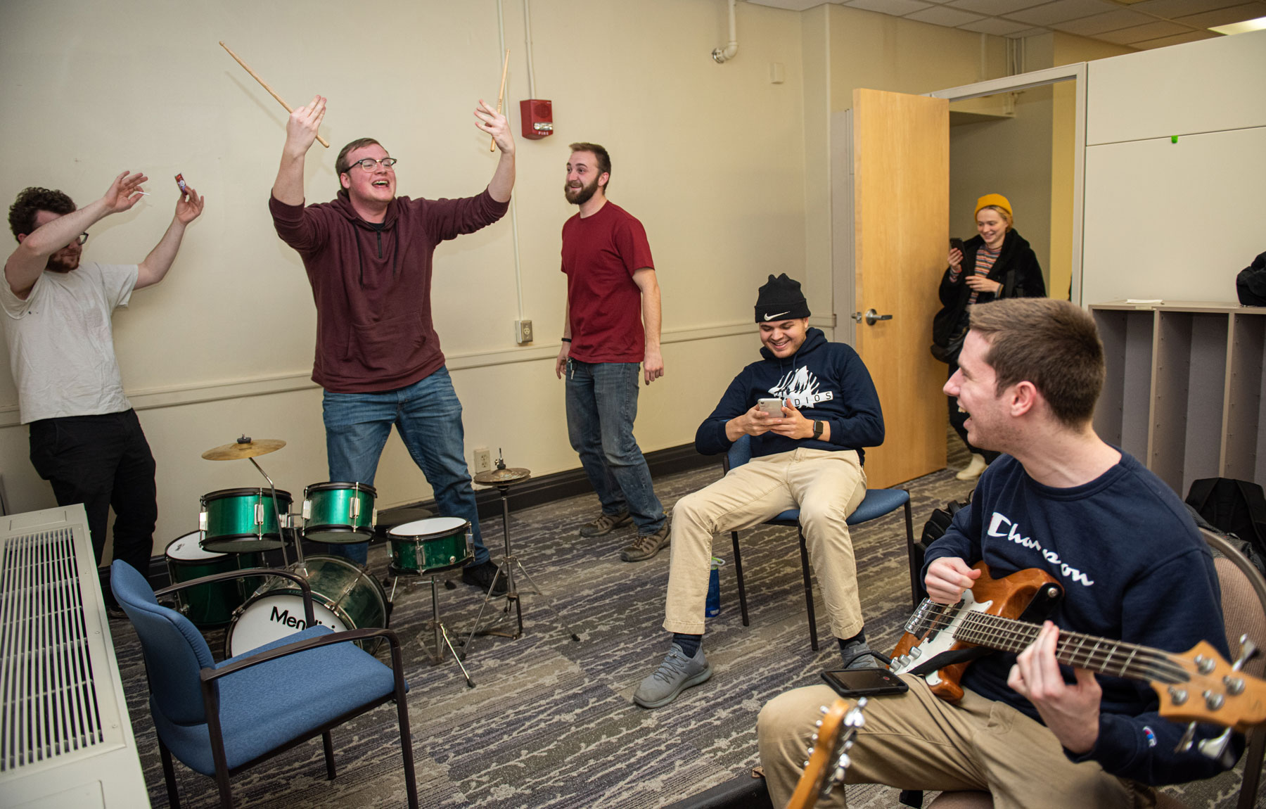 Students in a circle playing musical instruments