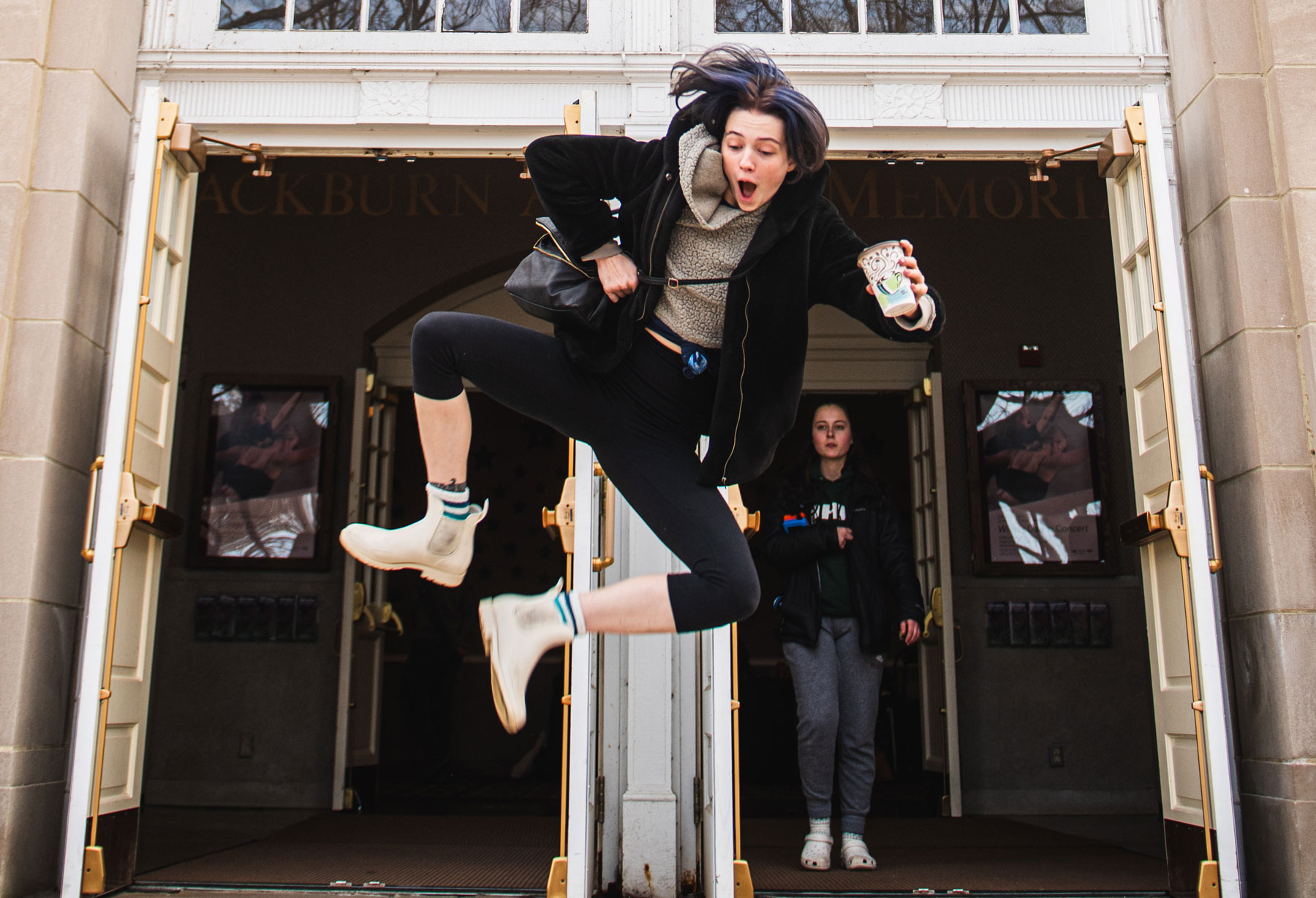 A woman jumping and doing a heel click in mid-air