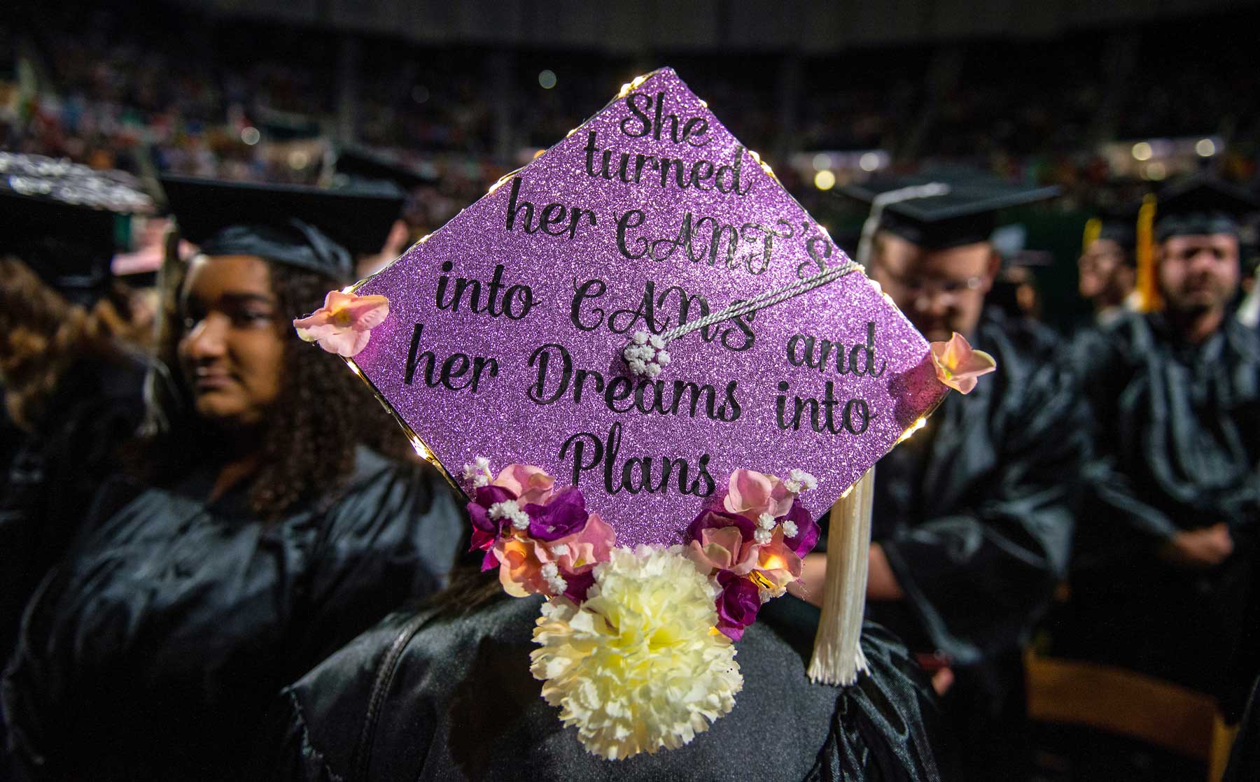 Picture of graduation cap that says, "She turned her CANT'S into CANS and her Dreams into Plans" on the top