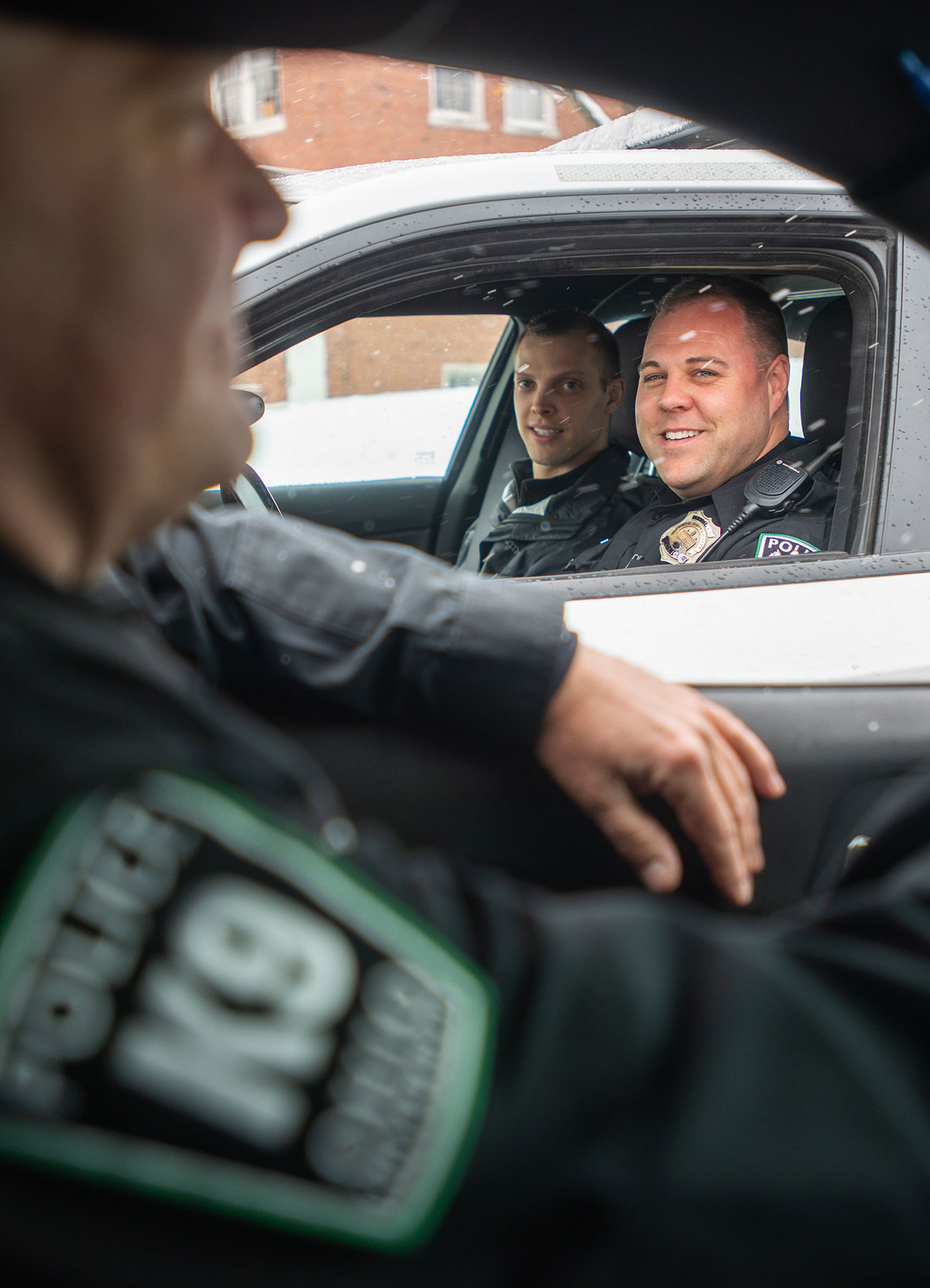 Two OUPD officers stop next to each other in their cars to chat