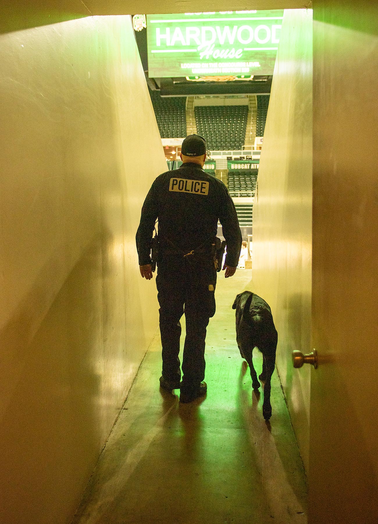 An OUPD K9 officer walks through a corridor in the Convocation Center