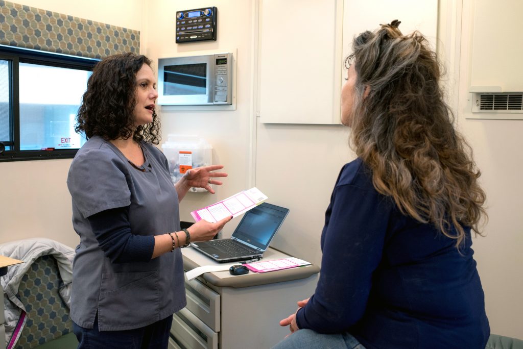 A College of Medicine medical provider speaks with a patient