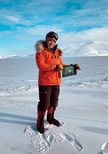 A member of the first carbon-neutral research expedition to the polar regions, Adanin still managed to pack a little Bobcat pride, posing with an OHIO flag that made the journey with her. Photo by Heidi Sevestre