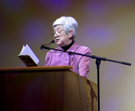 Ellen Bryant Voigt reading verses from her book at a podium