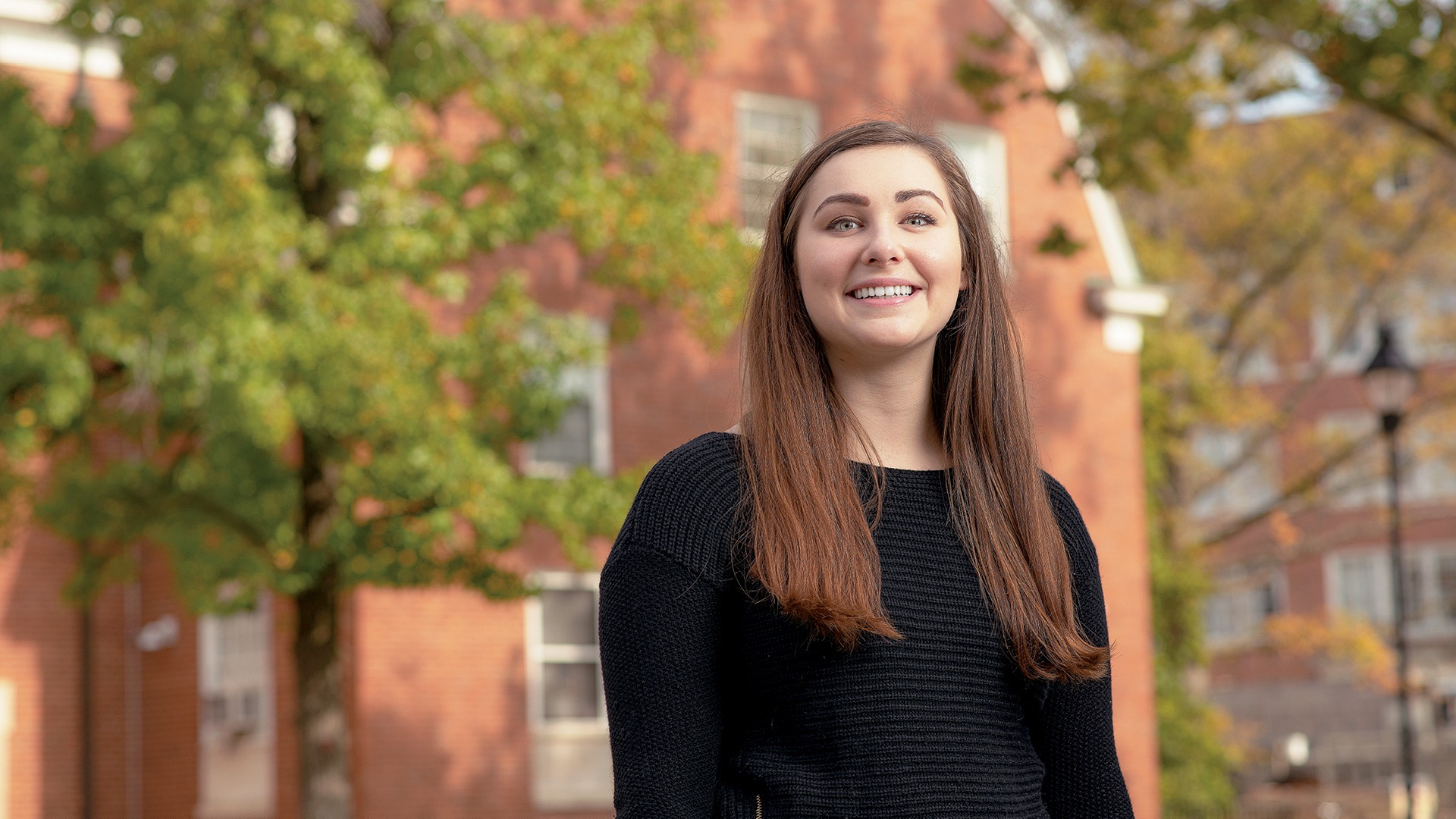 Bella Miller poses outside of residential halls.