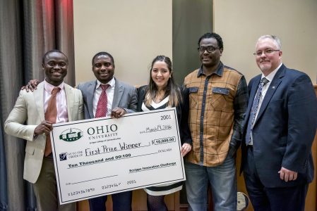 On March 14, 2016, after presenting team Ubuntu; Kingsley Antwi-Boasiako, Samuel Antwi, Ayleen Cabas Mijares, and Goitom Megash (Left to Right) with an oversized reproduction check for $10, 000 at the Scripps Innovation Challenge at Walter Hall Rotunda, Dean Scott Titsworth and the team pose for a picture to commemorate the event