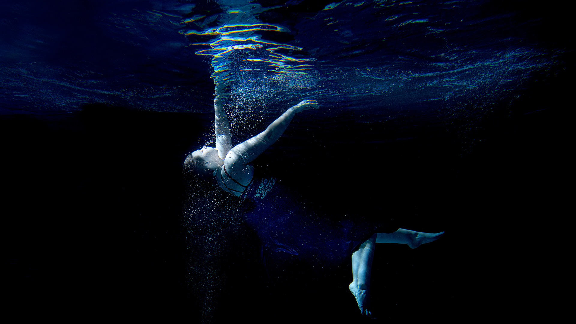 women swimming underwater