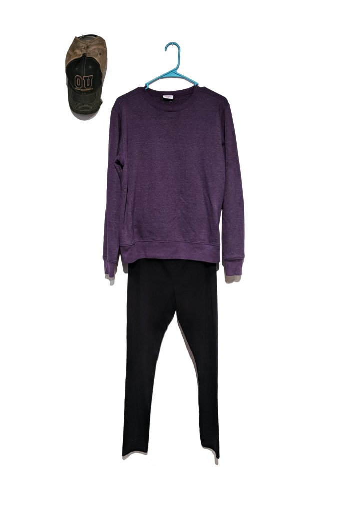 Purple sweatshirt, jeans and an Ohio University baseball hat