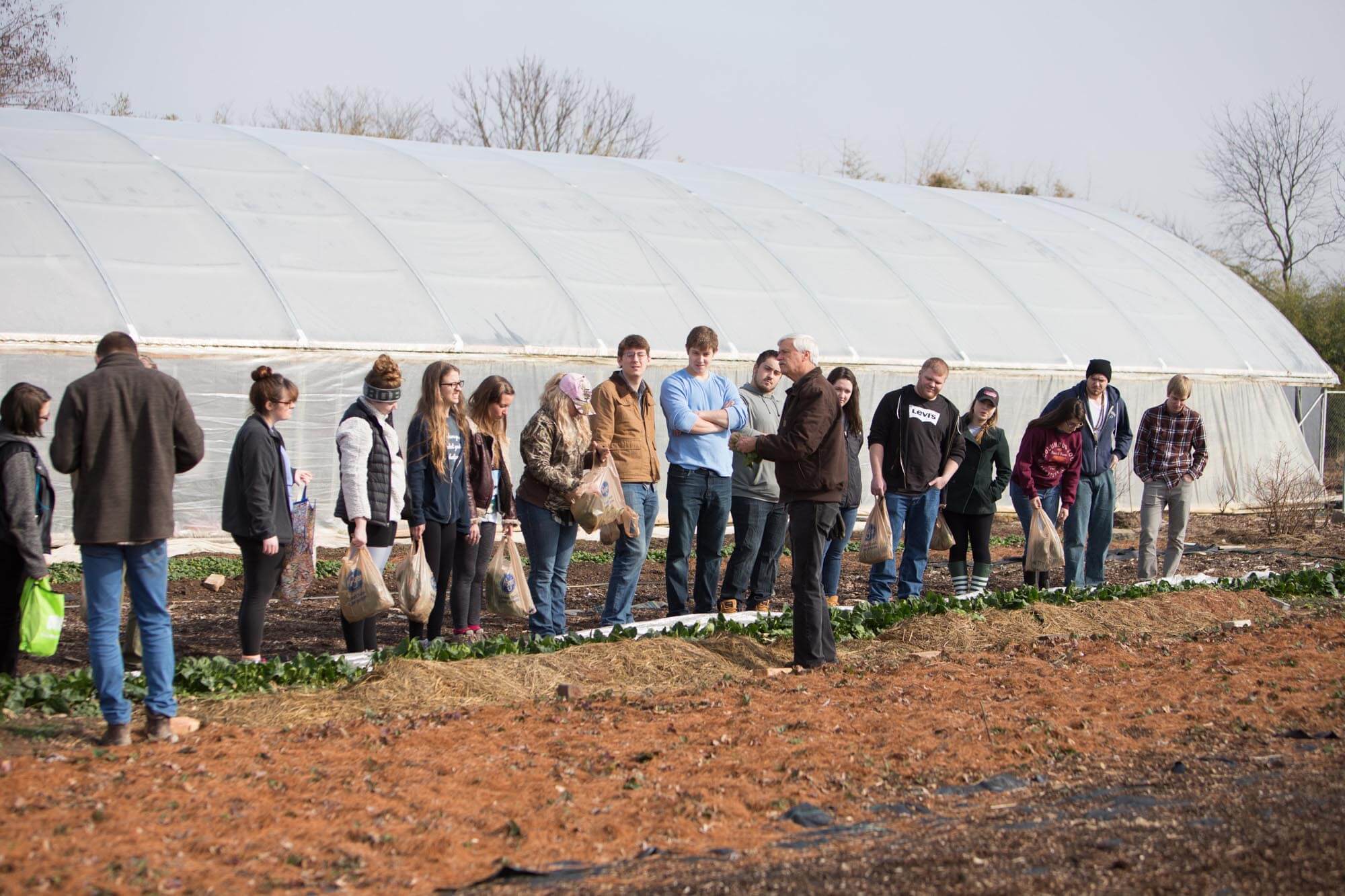 Arthur Trese, associate professor of environmental and plant biology (middle), talks to student produce-growers after a harvest at the Plant Biology Learning Gardens. Photo by Alexandria Polanosky, BSVC ’17