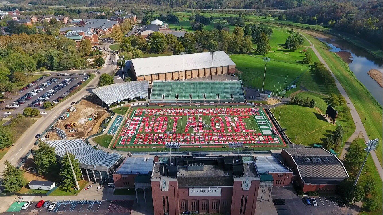 At ground level, The Monument Quilt is a massive mosaic of reds and whites. From the view of a drone, the display spells “Not Alone,” a message of public support to survivors, rather than of public shame. Photo by Mallory Golski, BSJ '19