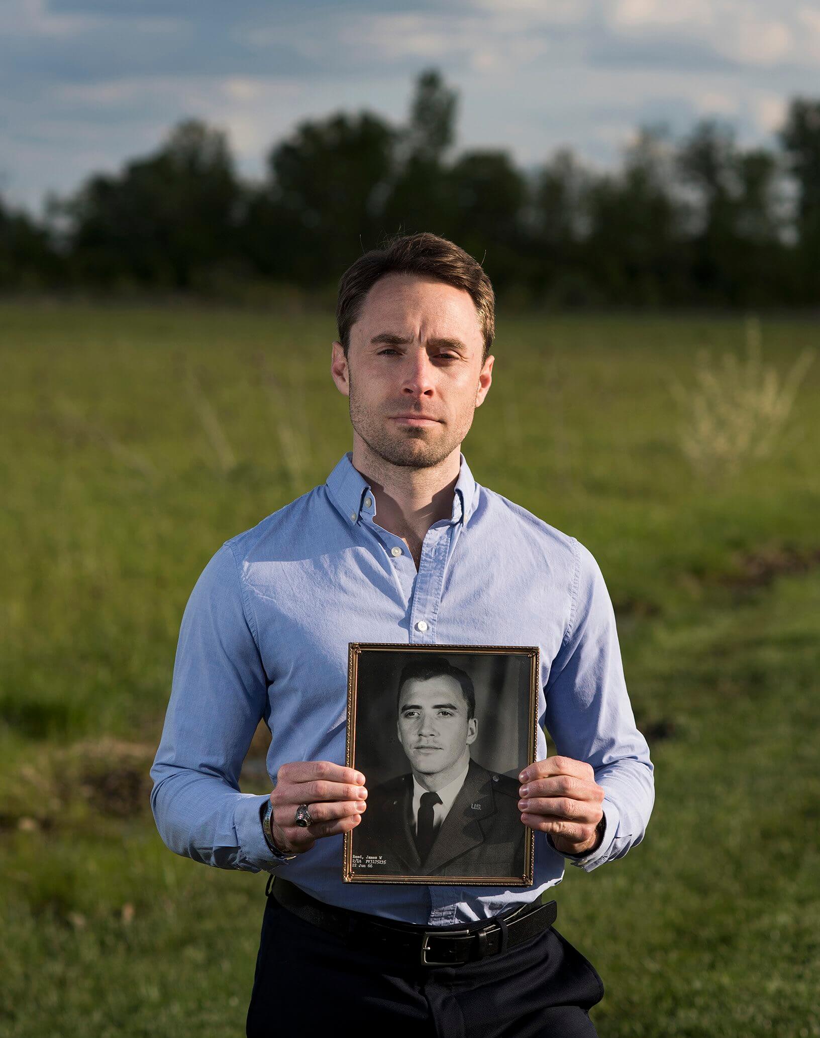 Jeff Reed holds a photo of his late great-uncle, Maj. James W. Reed, BSJ ’66, who died while serving as an F4 fighter pilot during the Vietnam War. 