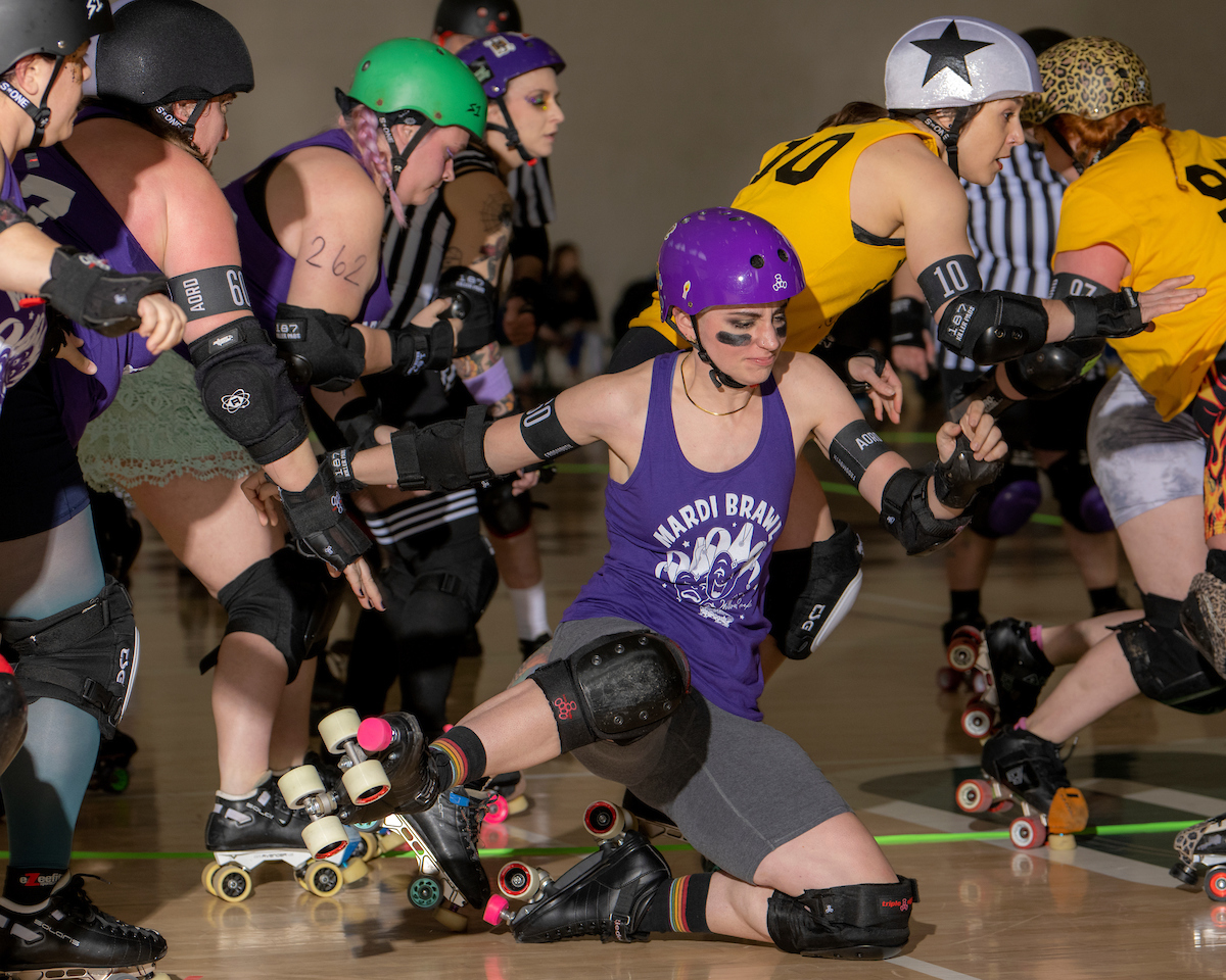 A group of roller derby athletes in action