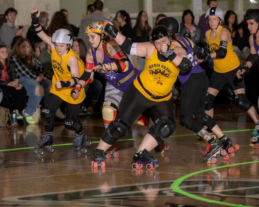Roller derby players mid-bout