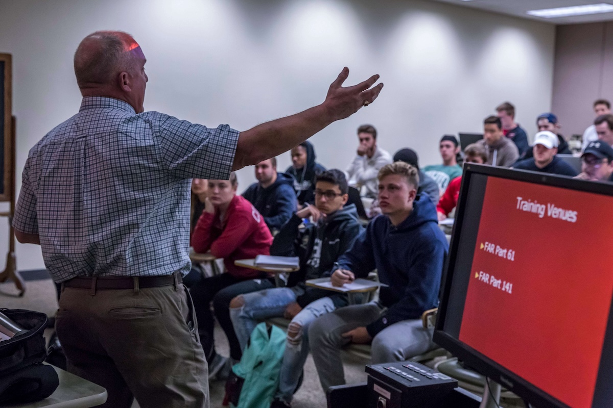 Teacher presenting to small group of students in classroom