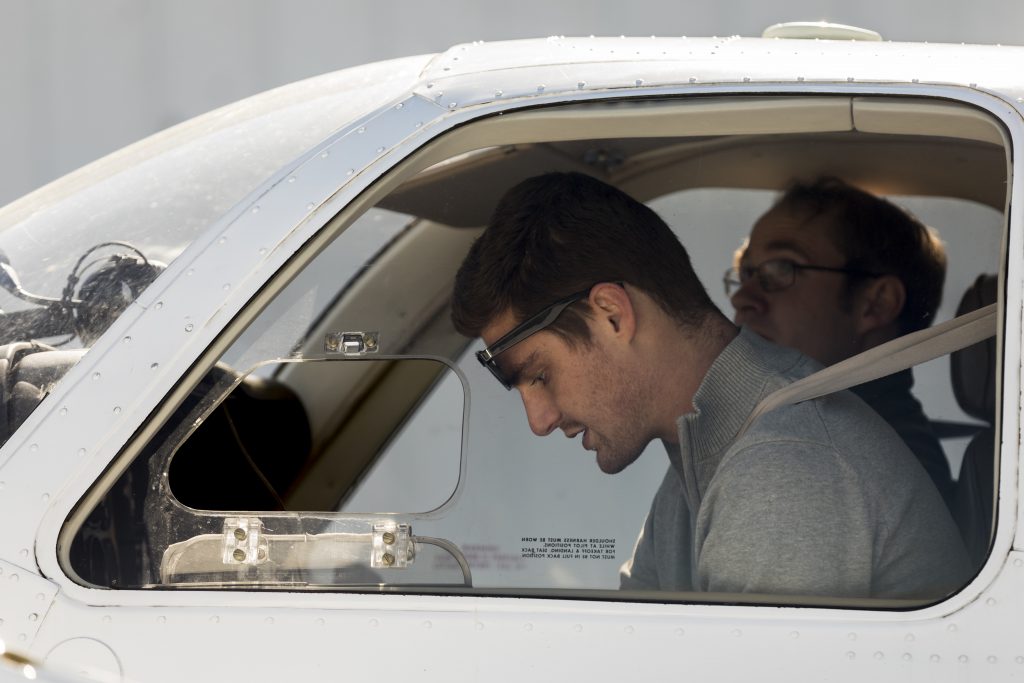 two pilots sitting in a plane 