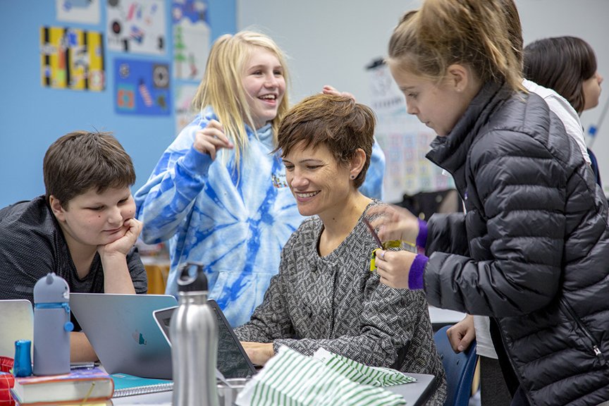 students in a classroom around a teacher