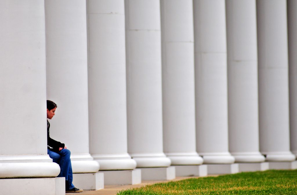 Students find unexpected places to sit between classes, including the columns of Margaret M. Walter Hall. The building has many nooks and crannies, perfect for work or relaxation. 