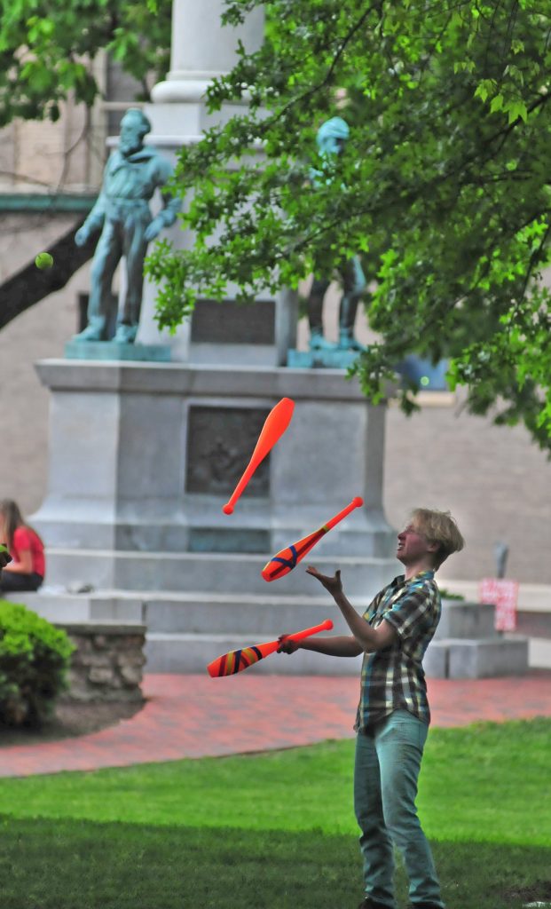 The warmer the weather, the more students flock to College Green. While many prefer to just lounge, this student practiced juggling.