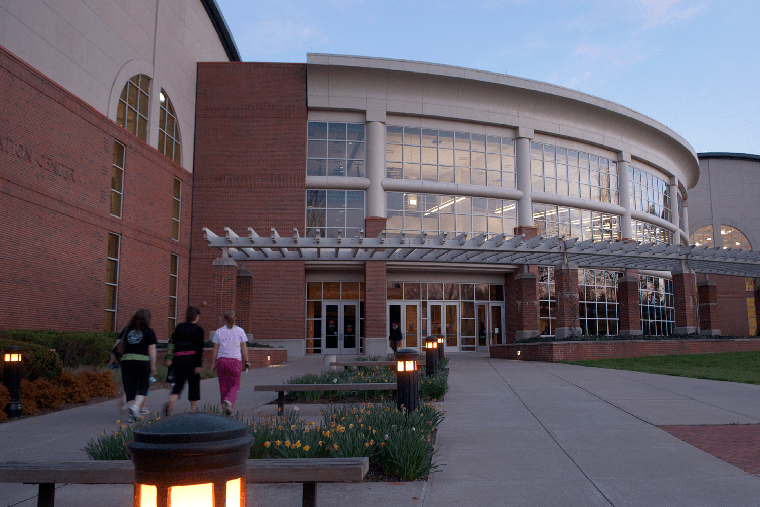 Several people walk in and out of The Ping Center, Ohio University's gym