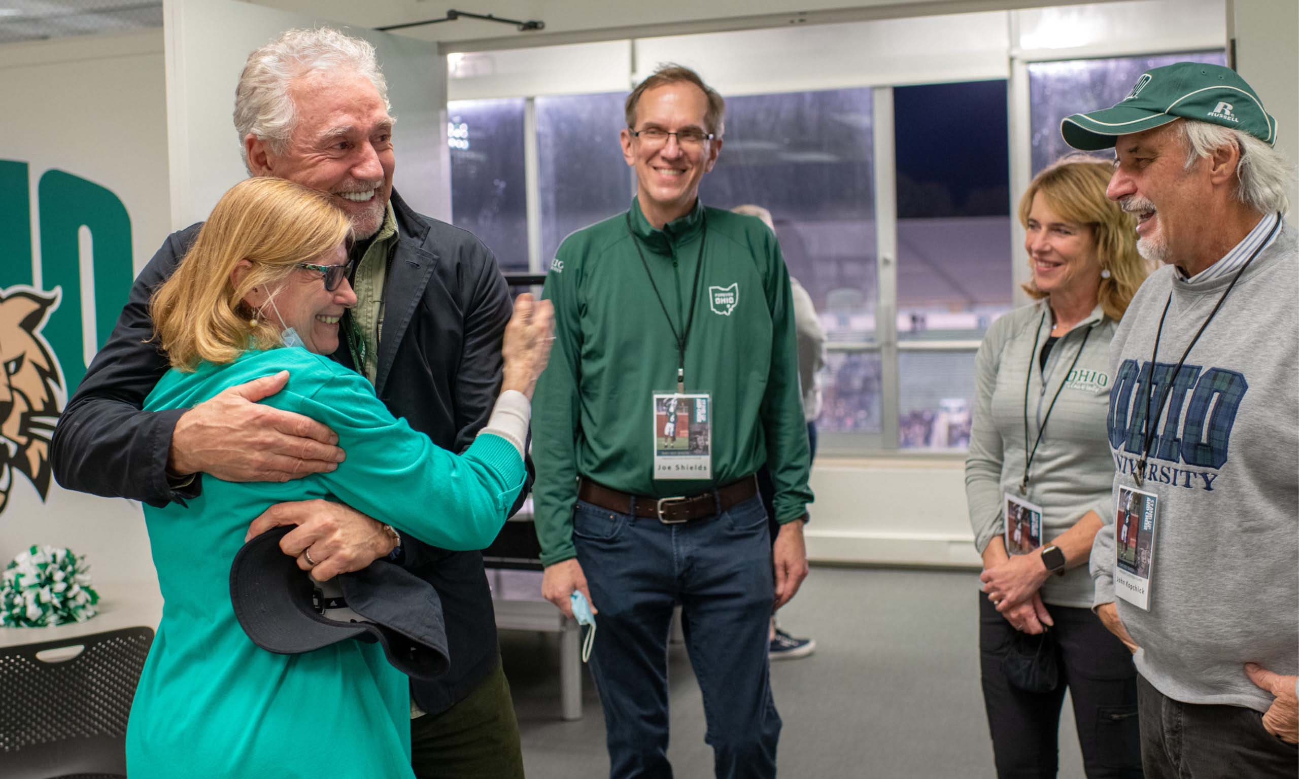 Rick Hawkins’ Nov. 2 return to campus just happened to fall on Dr. John Kopchick’s 70th birthday. They ended the day by attending the OHIO Football game, with Hawkins, a former Bobcat football player himself, pictured here hugging Char Kopchick while (from left) Drs. Joseph Shields, Darlene Berryman and John Kopchick look on. 