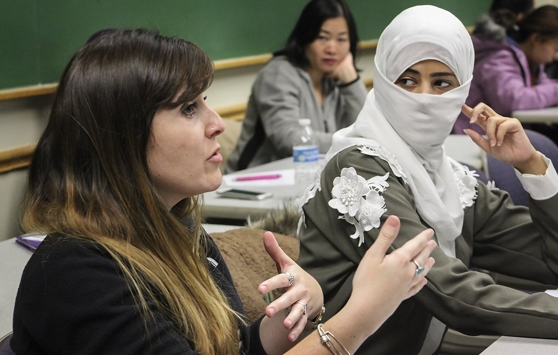 women speaking in a classroom 